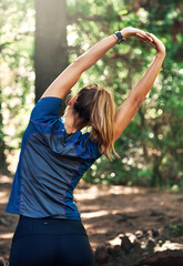 Woman, stretch and arms in forest for run on trail in nature for fitness, summer and training for sport. Health, active and sportswear for hike with blood flow, muscle tension and flexibility.