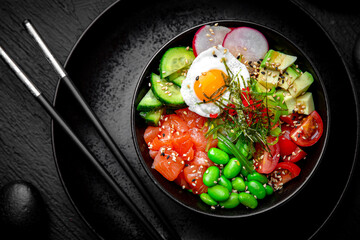 Salmon Poke bowl composition on black background. The Art of Japanese Cuisine. Food photography for...