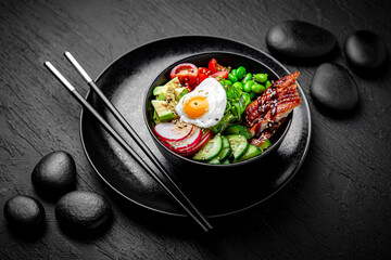 Smoked Eel Poke bowl composition on black background. The Art of Japanese Cuisine. Food photography for menu and sushi bar decoration