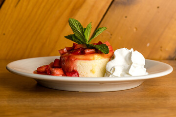 Individual serving of cheesecake with strawberries and whipped cream