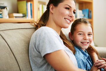 Child, portrait and woman with hug on sofa in living room for bonding, connection or relax together. Family, smile and mom with girl in embrace at home for motherhood, love and care on weekend