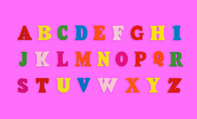 wooden letters of the English alphabet multi-colored on a pink background