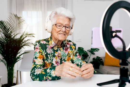 Elderly woman recording creative podcast at home