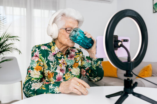 Elderly woman influencer recording a video podcast