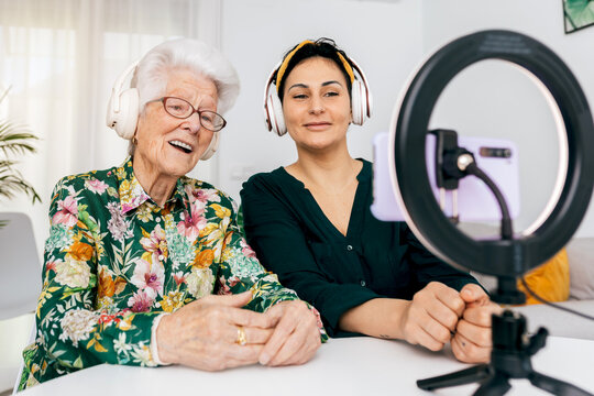 Young and elderly woman recording a podcast together