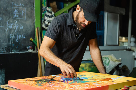 Latin American Artist Painting in His Studio
