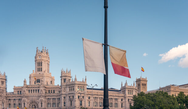 Blank and Spanish flags before Madrid historical building