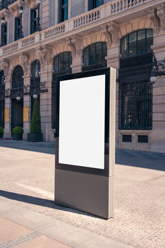 Blank advertising billboard in sunny Madrid cityscape