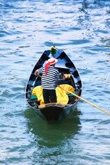 Gondolier Navigating The Canal Of Venice Italy Europe