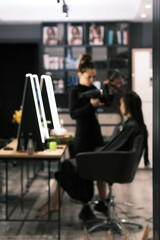 Hair stylist working in a salon with a customer