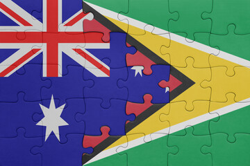 puzzle with the colourful national flag of guyana and flag of australia.