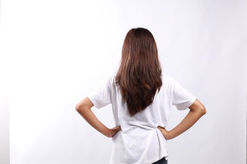 Back view of young asian woman in casual with hand on her waist, isolated on white background