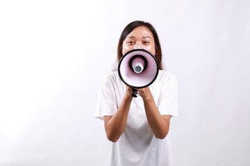 Young asian woman hold scream shout in megaphone announces discounts sale Hurry up isolated on...