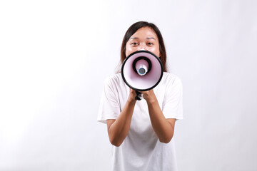 Fototapeta premium Young asian woman hold scream shout in megaphone announces discounts sale Hurry up isolated on white background studio portrait.