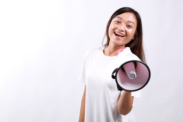 Young asian woman hold scream shout in megaphone announces discounts sale Hurry up isolated on...