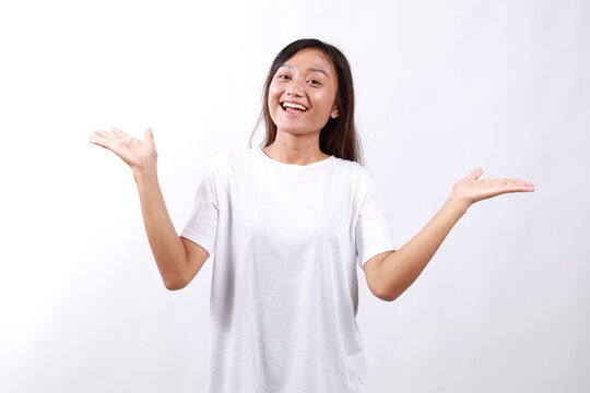 Surprised and happy young asian girl realized she won, receive really good news, spread hands sideways smiling and look amazed at camera, standing white background lucky and upbeat