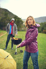 Wind, woman and rain at barbecue in outdoor on vacation or picnic as family in together. Female...