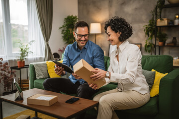 Mature woman and adult man check packets on clipboard at home