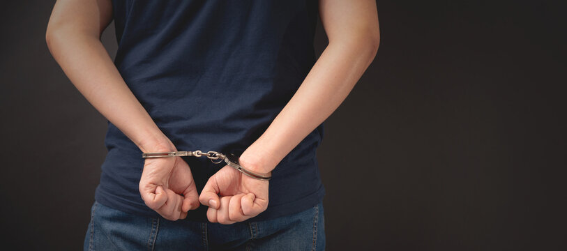 Arrested man with handcuffed hands