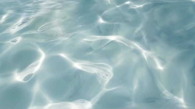 Shimmering blue water surface seamless loop video background, perfect for summer, travel, and relaxation themed projects. Summer Relaxation Concept.