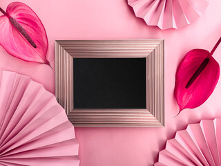Elegant Pink Background with Blank Blackboard Frame and Vibrant Anthurium Flowers.