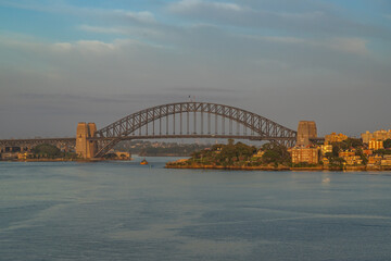 Extraordinary view of Sydney's Icons, namely the Sydney Opera House, Sydney Harbor Bridge and Sydney Downtown, while arriving by cruise ship in a beautiful sunrise.