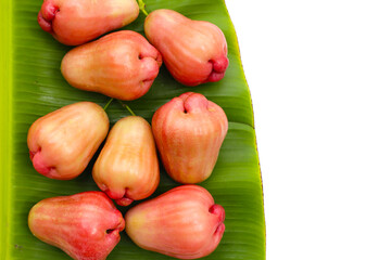 Fresh rose apple fruits on banana leaf