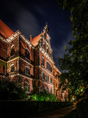 Illuminated, brick, historic building of National Museum in Wroclaw at night