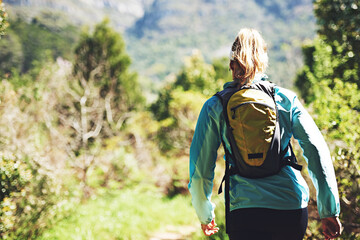 Back, walking and woman hiking on trail in nature on outdoor adventure to explore on holiday...