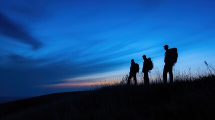 Silhouetted Hikers at Dusk on Hilltop