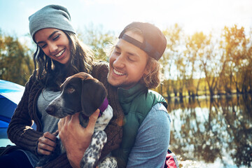 Happy, camping and couple with dog for adventure by love of freedom in nature lake, sunshine and...