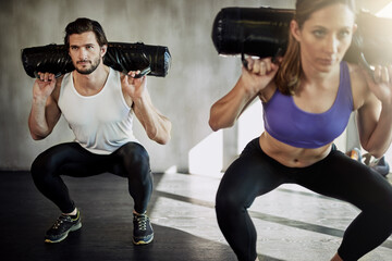 Man, woman and squat with sandbag weights for exercise performance, training or muscle. Personal...