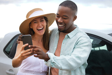 Love, interracial couple and smile for selfie on road trip, travel or countryside for vacation in...