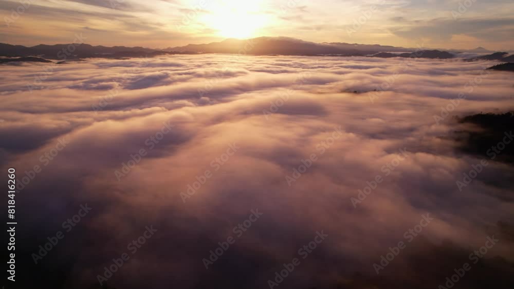 Wall mural Aerial View Flying over fog in sunrise sky,Colorful sky beautiful ocean of clouds at sunrise, Sun is rising above the endless sea of clouds until the horizon, Amazing nature landscape background