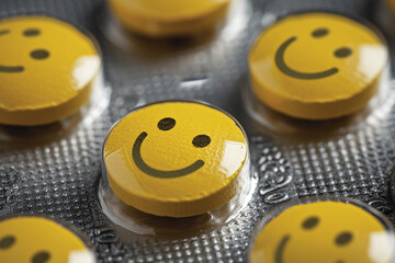 A group of yellow pills with smiling faces on them. happy concept