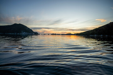 World heritage port davey national park in tasmania Australia, with mountains and river. boats in a bay in the evening