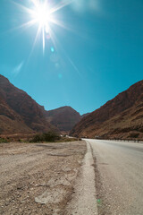 A road through a valley on a hot sunny day without cars reminding abandoned areas