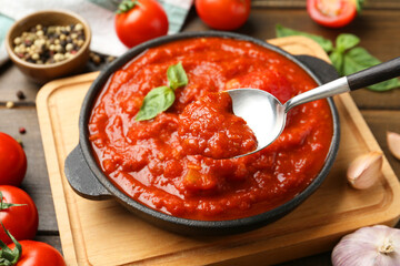 Eating homemade tomato sauce at table, closeup