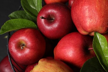 Fresh ripe red apples with water drops in metal bowl, closeup