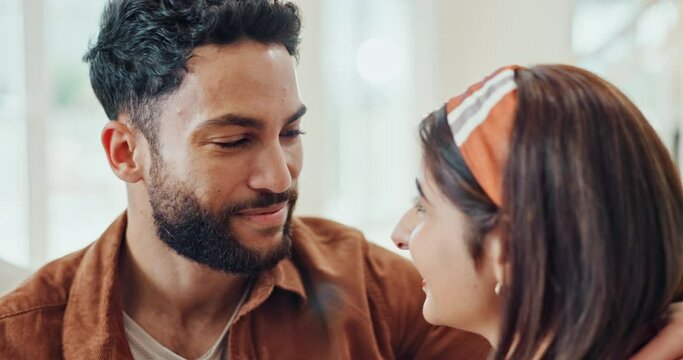 Happy, couple and home with kiss on forehead with love, care and marriage with an embrace. House, relax and living room with smile, trust and romance together on a sofa with support and bonding