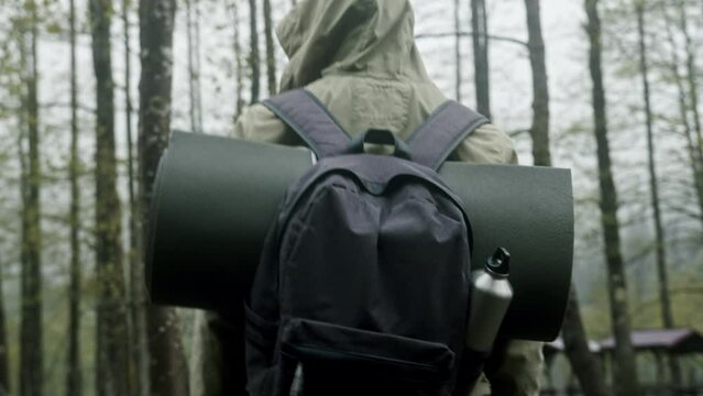 Immersive Outdoor Experience: Back View Stock Footage of a Camper with Bedroll and Backpack, Embracing the Wilderness Adventure Ahead