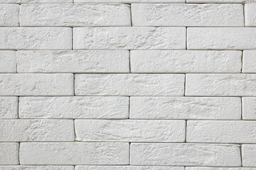 A white brick wall with a rough texture