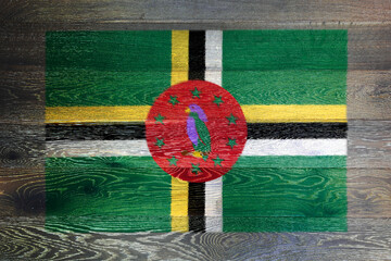 Dominica flag on rustic old wood surface background