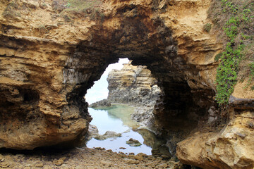 Natural rock formation with an archway at The Grotto on the Great Ocean Road in Victoria, Australia