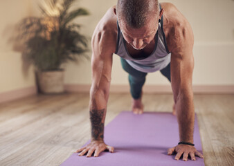 Fototapeta premium Man, yoga and high plank pose for wellness, health or body flexibility for practice routine with strength. Relax, zen yogi or person in pilates session for mindfulness, wellbeing or balance on floor