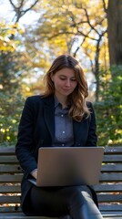 Businesswoman Working Remotely in Vibrant Autumn Park Environment