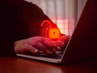 Cyberattack and internet crime, scam, hacking and malware concepts. Unlocked padlock icon on red digital binary code data numbers on dark virtual screen while hacker's hands typing on laptop computer.