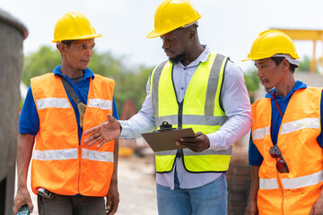 Foreman and workers team meeting for planning project at construction site, Site manager and...