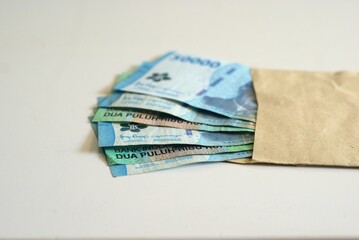 Indonesian Rupiah banknotes in envelope isolated on white background, business and finance concept, financial budgeting and earnings