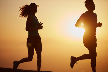 Couple, silhouette and sunrise workout in outdoor, running and cardio challenge or marathon...